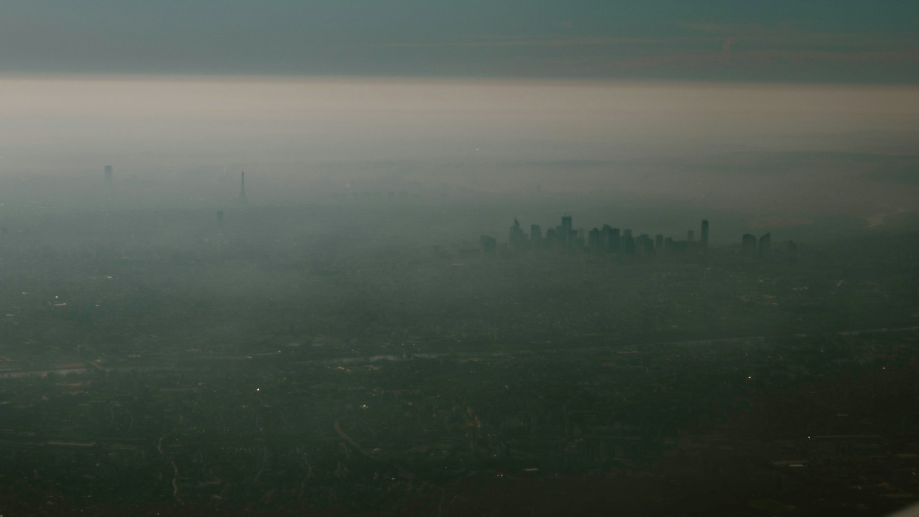 City skyline shrouded in dense smog.